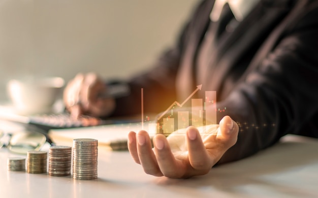Photo financial growth graph on hand, business people are documenting office finance, financial ideas and loan investments.